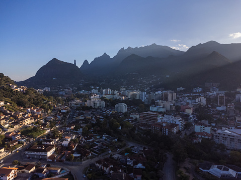 Aerial view of the city of Teresópolis. Mountains and hills with blue sky and many houses in the mountain region of Rio de Janeiro, Brazil. Drone photo. Araras, Teresópolis. Sunny day. Sunset.