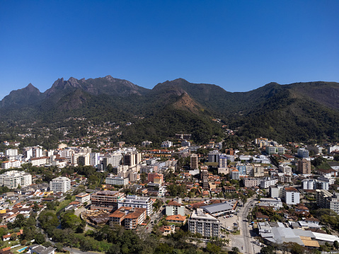 Aerial view of the city of Teresópolis. Mountains and hills with blue sky and many houses in the mountain region of Rio de Janeiro, Brazil. Drone photo. Araras, Teresópolis. Sunny day. Sunrise.