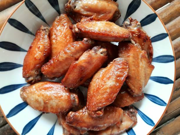 istock Grilled Chicken wings on plate - food preparation. 1416946607