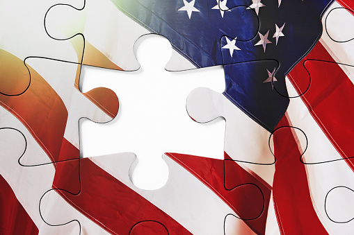 Representing problems and solutions, a jigsaw puzzle of the Stars and Stripes, with a gap for the last missing piece.