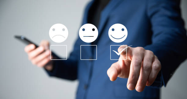 istock man select face emoticon on virtual screen at smartphone 1416949678
