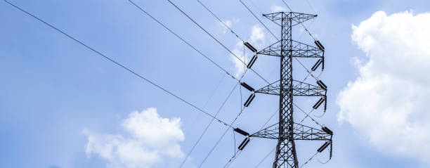 istock High voltage poles with sky and clouds in the background. 1416953471