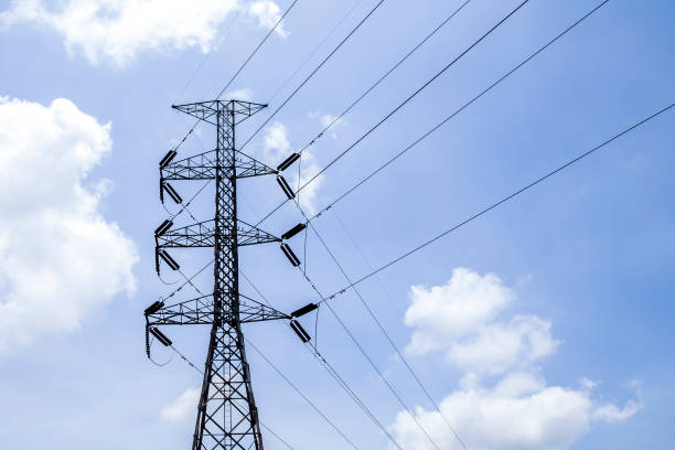 istock High voltage poles with sky and clouds in the background. 1416953575