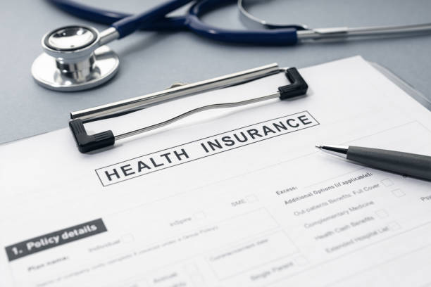 Health Insurance form and stethoscope on desk stock photo