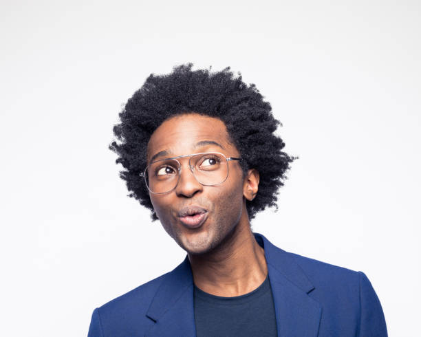 Excited businessman laughing away Headshot of cheerful businessman wearing navy blue suit jacket looking away. Studio shot against white background. whistling stock pictures, royalty-free photos & images