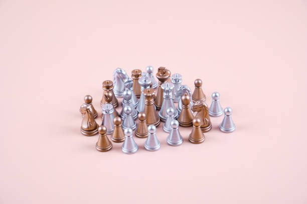 istock Gold and silver chess pieces mixed in one pile. 1416957443