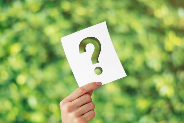Holding note paper with Question Mark on blurred nature background stock photo