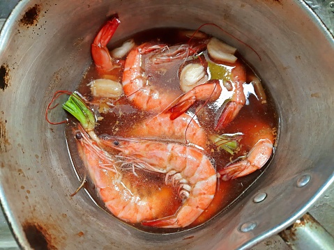 Spicy Thai seafood soup (Tom Yam Ruam Mit). This famous Thai dish is very spicy and made with lemon grass, kaffir lime leaves, galangal and chili.