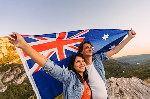 Woman enjoy with the British flag in hand on top of Gibraltar Rock. Gibraltar is a territory of South West Europe Which is part of the United Kingdom.