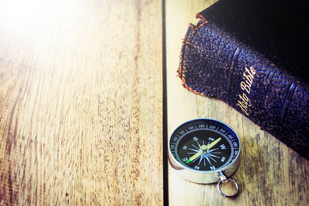 istock the compass and the holy bible on wooden table background, 1416972010