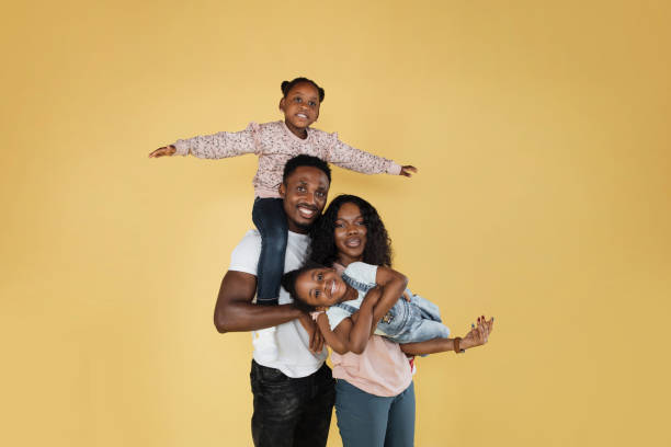 istock Cheerful african man holding excited daughter on hands 1416974648