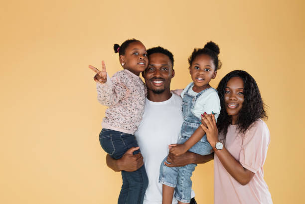 istock Cheerful father and mom carrying daughters, banner 1416974716
