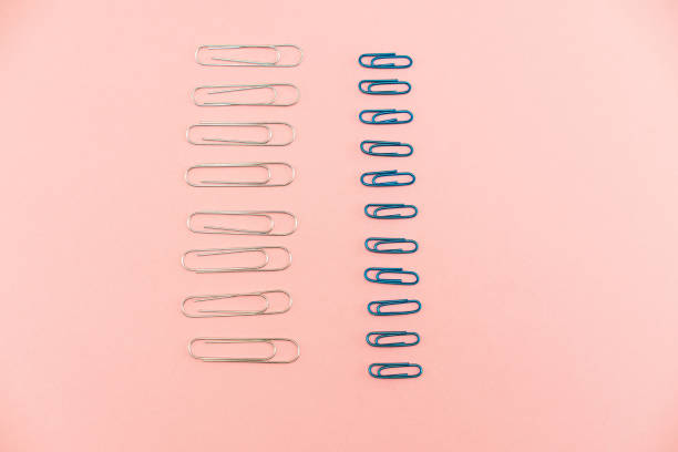 Paper clips in silver and blue on pink background. Data viz-inspired layout.