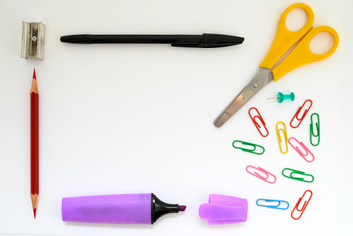 school supplies marker paper clips ruler pen scissors and pencil closeup white background wallpaper