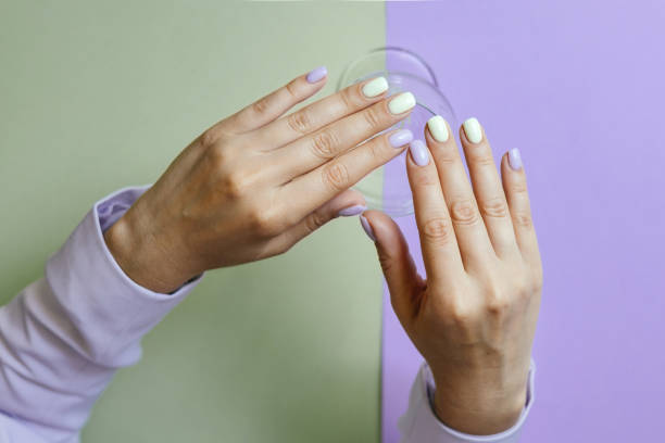 istock Beautiful purple manicure on a milky background. 1417004617