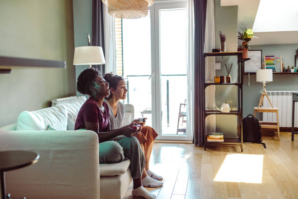 istock Young multicultural group of female friends playing games on console 1417005085