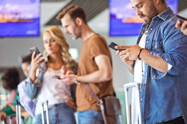 istock Young man using smart phone at airport 1417006541