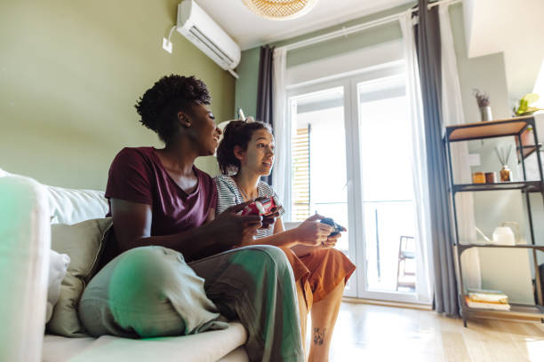 istock Young multicultural group of female friends playing games on console 1417006843
