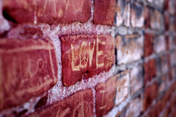istock Love Symbol Written on Old Brick Wall 1417007019