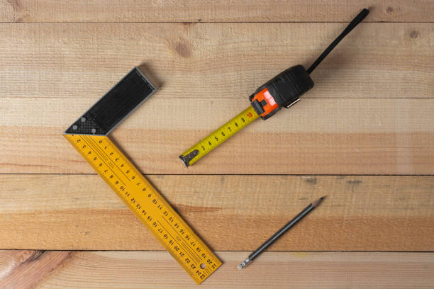 istock A square, yardstick and a pencil. Tool for measuring. Joiner's (carpenter's) workshop. Close-up. 1417007400