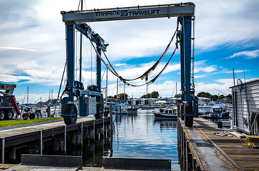 A boatyard located on Falmouth Harbor, Falmouth, MA on Cape Cod.  Photos show a lift and large covered work garage for the yachts.