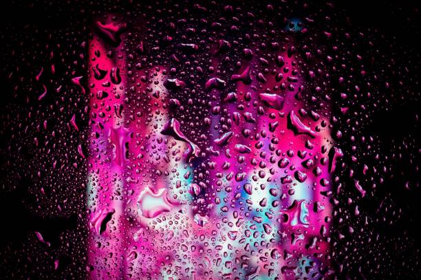 istock Christmas lights behind the wet glass 1417012067