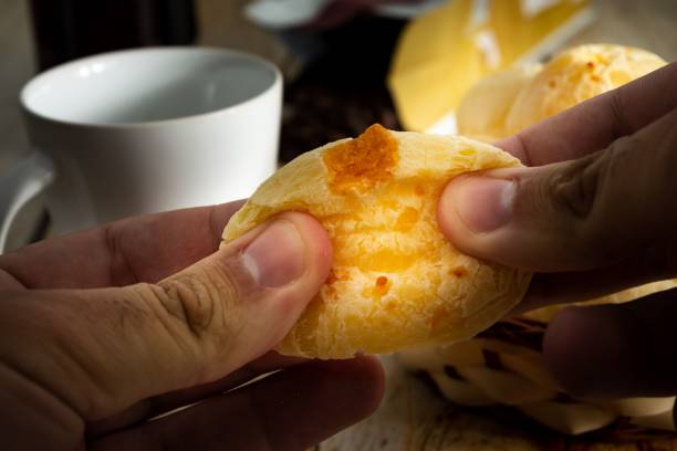 istock hands opening a cheese bread or cheese bun in half 1417012187