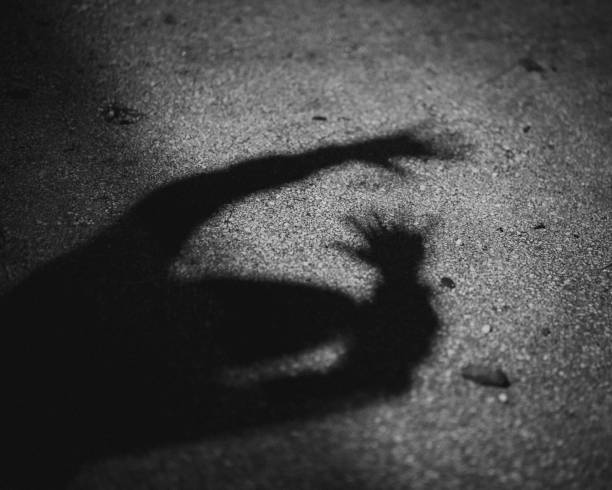 istock Scary silhouette of a man on the ground 1417012312
