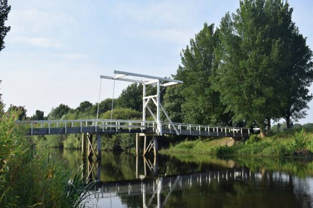 istock Landscape view with a white drawbridge over a river 1417013099