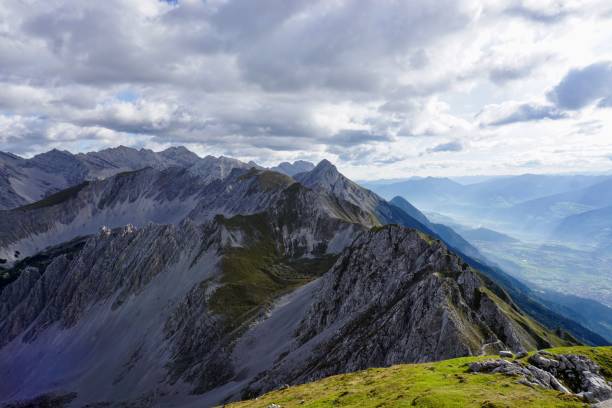 istock Beautiful view of snowy mountains and clouds over them 1417015309