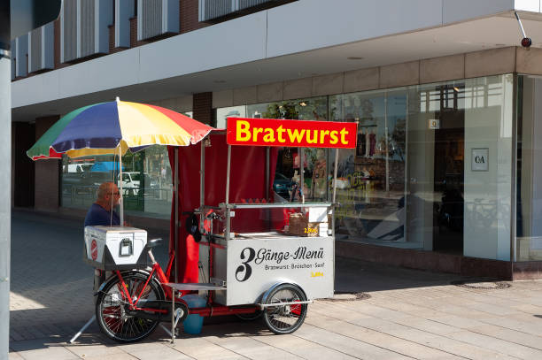 Wolfsburg, Germany - August 12, 2022: A street seller of grilled German bratwurst sausages