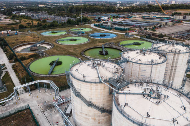 aerial view above waste water treatment plant with green algae - sewage pond imagens e fotografias de stock