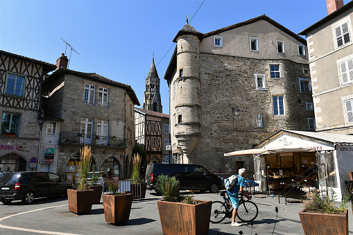 Saint-Leonard-de-Noblat, France-08 04 2022:People in the old medieval town square of Saint-Leonard-de-Noblat in the Limousin region, Central France.