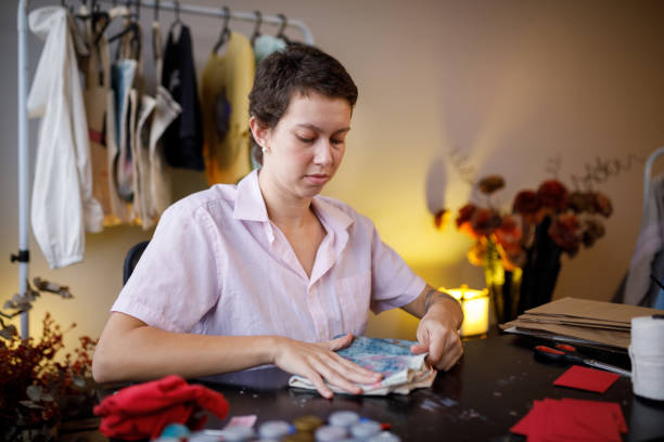 istock Artisan folding a reusable bag to ship to customer 1417020628