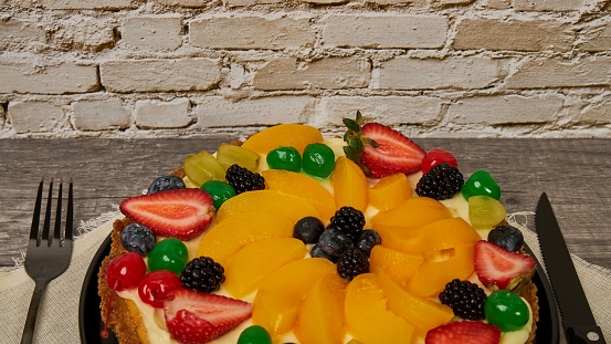 fruitcake with strawberries, blueberries, cherries and peaches, top view