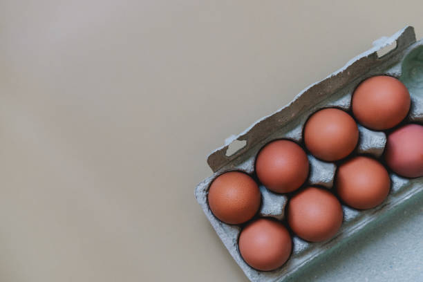 istock Chicken eggs in paper tray on light background. 1417021412