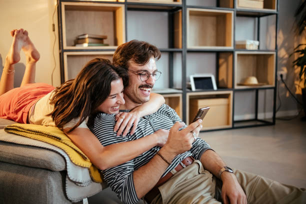 istock Cheerful couple using mobile phone 1417022709