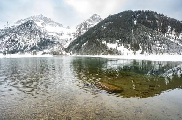 A beautiful landscape of a lake  in snowy Alpen mountains
