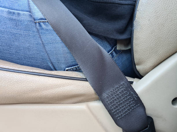istock Driver or passenger fastens seat belt in car 1417028069