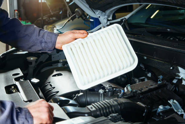 istock Scheduled vehicle maintenance, auto mechanic replacing air filter. 1417031065