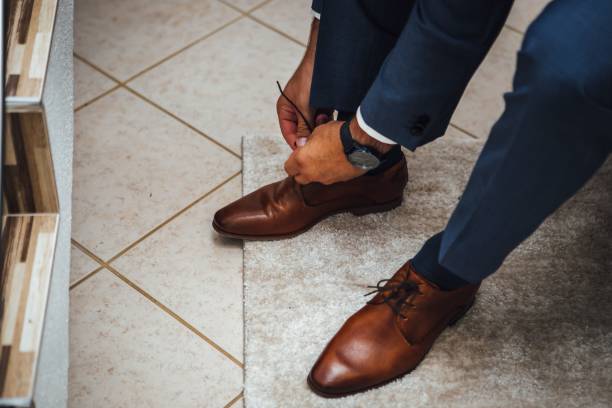 istock Person tying his classic leather shoes 1417032947