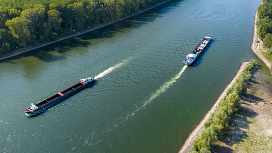 Industrial ships on river with a low water level - aerial view