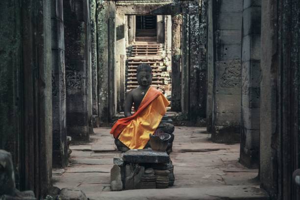istock Statue of Buddhist monk surrounded by walls in Angkor Wat 1417034472