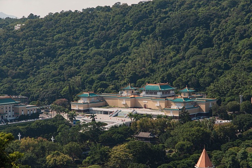 The National Palace Museum surrounded by dense trees in Taipei, Taiwan