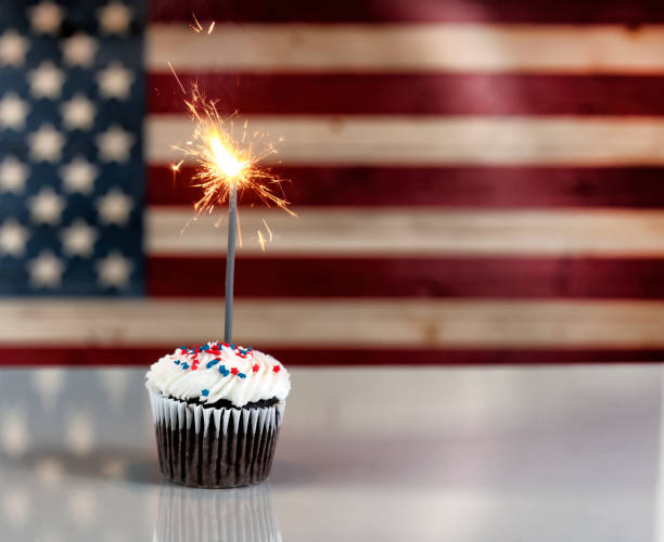 istock US Independence Day celebration with decorated cupcake and glowing sparklers with flag 1417035737