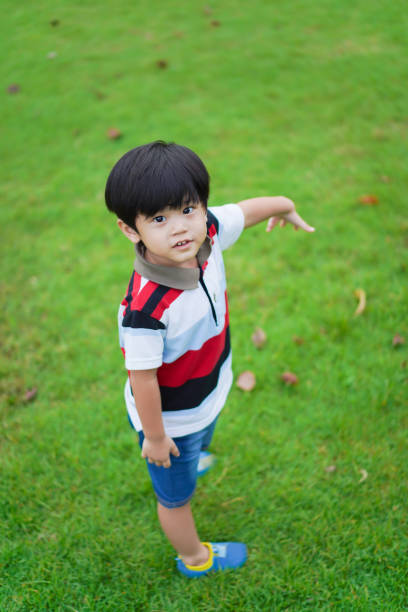 istock Happy young boy playing in the park. 1417037979