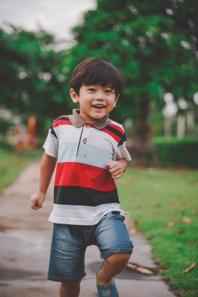 istock Happy young boy playing in the park. 1417038111