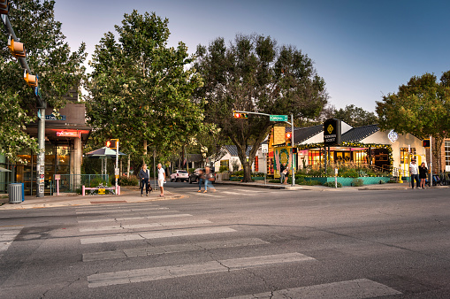 Austin, Texas, USA - November 15, 2021:  People walk along the trendy South Congress Street colourful shops and cool restaurants in Austin Texas USA.  This fashionable area is an increasingly popular shopping and dining district and serves as a creative hub.