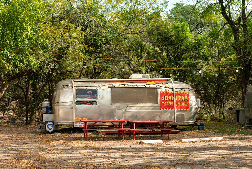 Austin, Texas, USA - November 15, 2021:  Mexican food truck in a silver RV camper van closed for business in a public park in Austin Texas USA