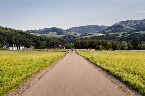 Bicycle trail Eurovelo 11 in Beskid mountains near Nowy Sacz. Landscape with sunny weather, meadows and mountains.